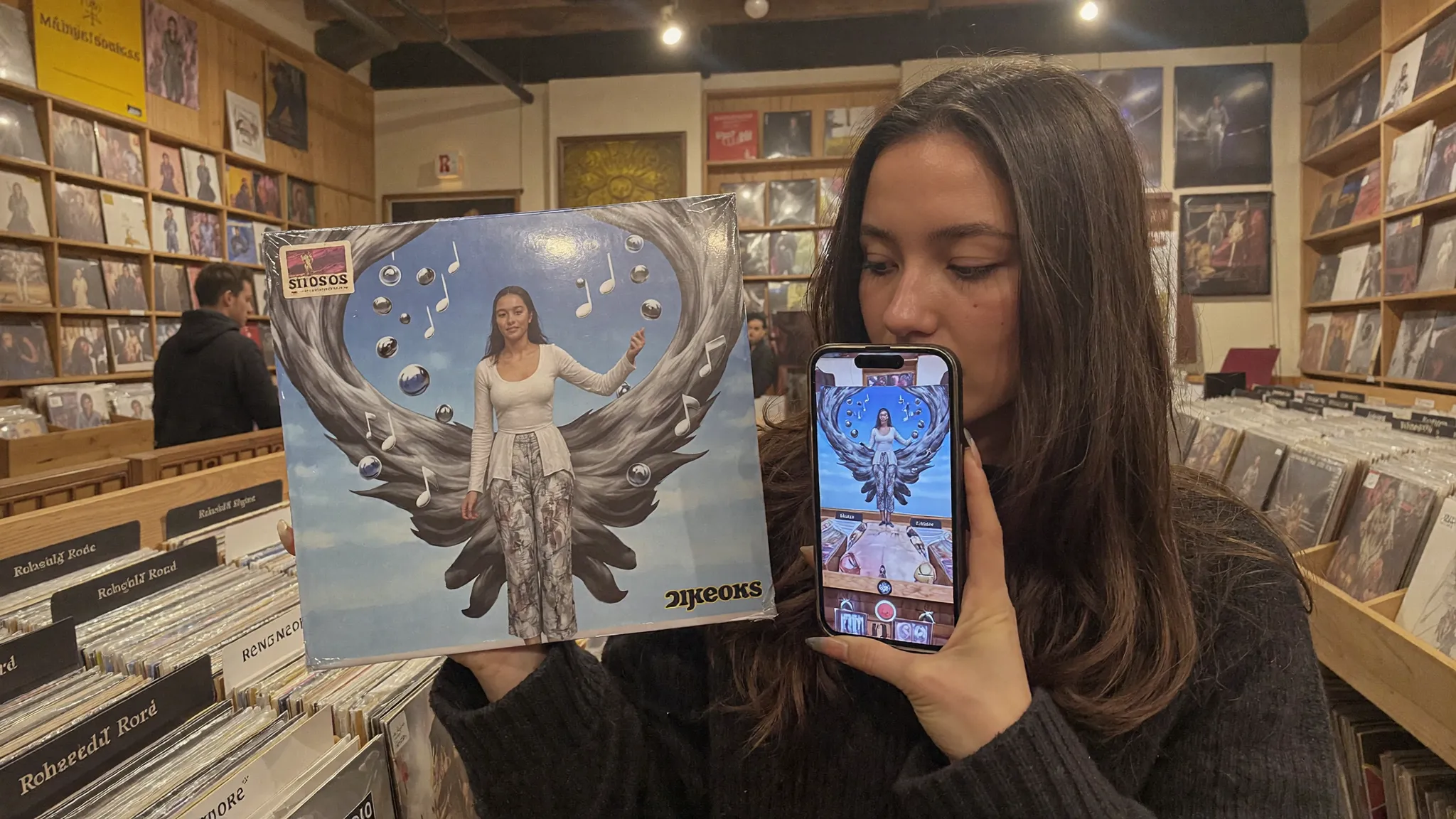Fan scanning a vinyl sleeve, album artwork bursting into AR